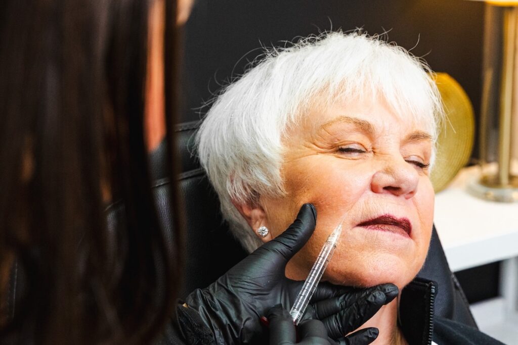 Close-up of a provider treating a patient's cheek with injectable fillers in Myrtle Beach.