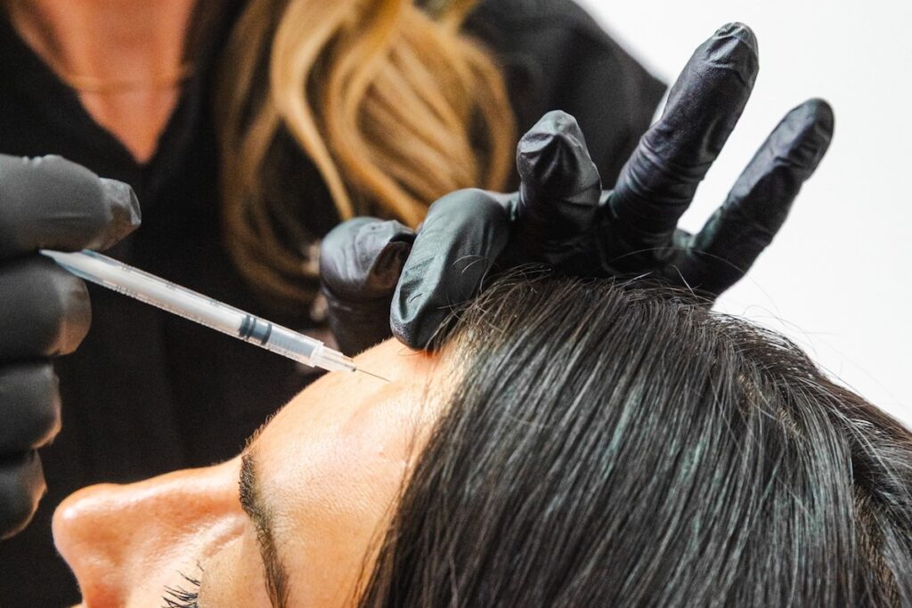 Close-up of a gloved provider treating a patient with preventive Botox in Myrtle Beach.